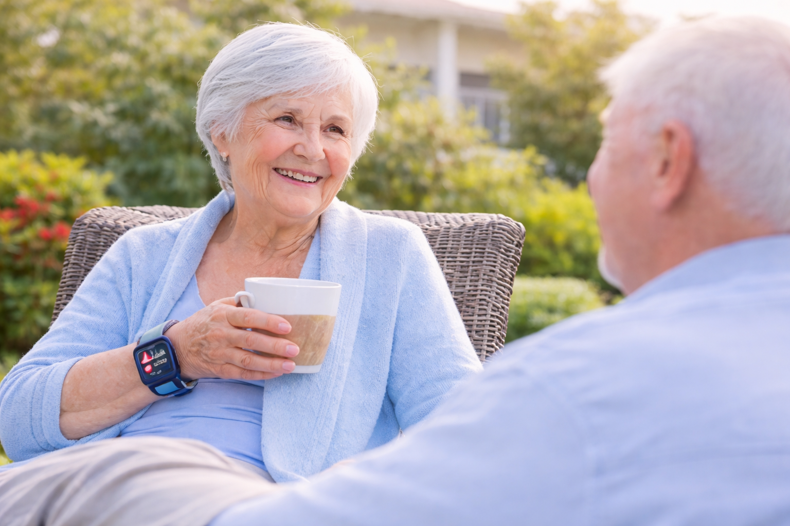 Senior woman wearing safety smartwatch while enjoying conversation outdoors